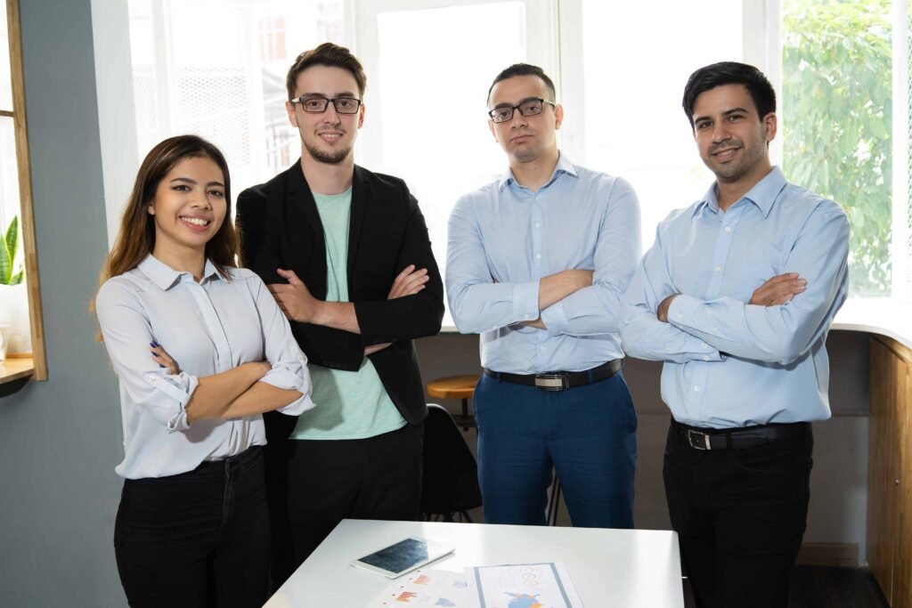 positive-successful-business-team-posing-workplace (1)-min